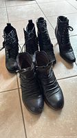 All three pairs of black ankle boots grouped together