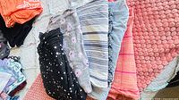Stack of assorted women’s pajama pants showing star, floral, stripe, pinstripe, plaid and solid colours