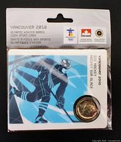 Front of factory-sealed coin sport card showing coin and hockey player artwork