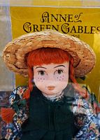 Close-up of doll face, hat, and yellow Anne of Green Gables insert