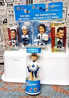 Front view showing all five sealed bobbleheads and packaging