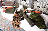 Full lot overview showing flashlight, sleep mask, ghillie strips, pouches, first aid dressing, stickers and patch