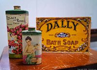 Front view of both tins and soap sign