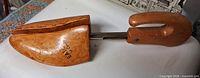 Top view of wooden adjustable shoe tree showing toe block split and metal slide