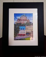 Front view showing cityscape print, white mat, black frame
