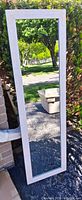 Front view of full-length mirror showing whitewashed frame and reflective glass