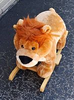 Front angled view showing full lion on wooden rocker