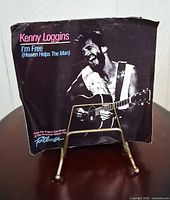 Kenny Loggins 7" single in picture sleeve on metal stand