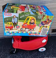 Cozy Coupe base with original box on top showing product images and branding