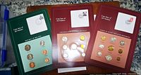 Front of Ireland, Czechoslovakia and USSR coin sets showing coins, stamp and postmark