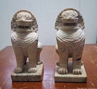 front view of both marble guardian lions on bases