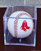Baseball in acrylic cube showing Boston Red Sox logo