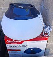 Front view of Sunbeam cool mist humidifier with original box