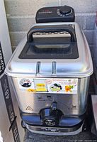 Front view of T-fal deep fryer showing stainless body, lid, control panel, exterior graphics