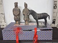 Front view showing both soldier figurines, horse figurine and patterned box