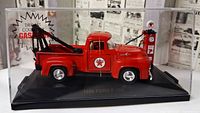 Full view of diecast Ford F-100 tow truck, gas pump, and display case