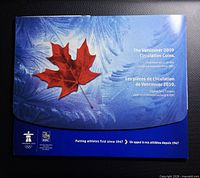 Front cover of tri-fold folder with maple leaf design and titling
