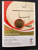 Front of numbered Royal Canadian Mint card displaying coin reverse with Olympic logo and Inukshuk design