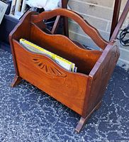 front view showing carved panel, handle, compartments