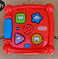 Top of cube with light-up animal buttons and speaker