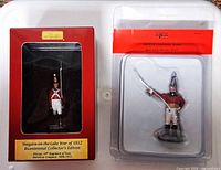 Front view of both sealed figurines in their original packaging