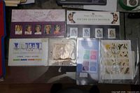 Six souvenir stamp sheets laid out in protective sleeves