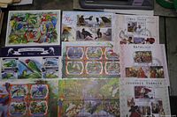 Group view of multiple souvenir sheets showing bird and art themes