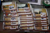 Stacked view of all twenty souvenir stamp sheets