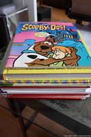 Stack of nine children’s books on table