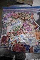 Full view of zip bag packed with assorted stamps