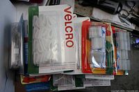 Stacked sealed Velcro hang-up clip packages showing branding and contents