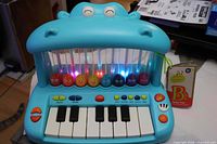 Front view of hippo-shaped toy showing keyboard, pop-up birds and controls