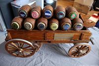 Full view of wooden beer wagon with barrels and caps