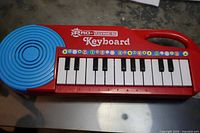 Pro-Tunes keyboard full view showing blue speaker, keys and handle