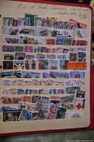 Full view of stock sheet filled with mixed Canadian and worldwide stamps