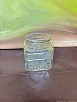 Front view of square pressed glass storage jar