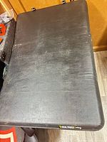 Top view of folded black vinyl tonneau cover
