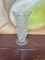 Full frontal view of clear cut crystal footed vase
