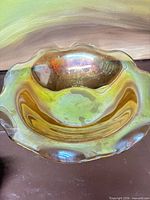 Top view showing marigold iridescence and ruffled rim