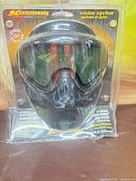 Front of sealed Karmor Vision System paintball mask in retail packaging