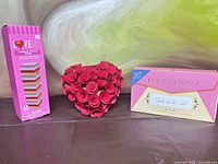All three items side by side: tower game box, rose heart, letters box