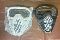 White and black Nerf Rival masks side by side