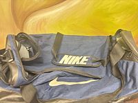 Exterior of Nike duffel bag with detachable pouch displaying NIKE logo