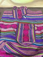 Front of woven backpack showing striped pattern and front pocket