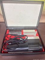 Open case showing dryer, attachments, cord