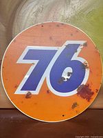 Front of circular metal sign showing Union 76 logo and distressed spots