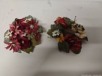 Both artificial floral arrangements side by side showing overall design and colors