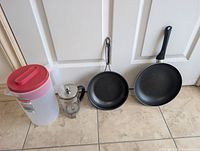 Group shot showing both frying pans, French press, and pitcher