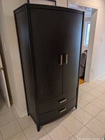 Full front view of closed armoire showing finish, handles, drawers