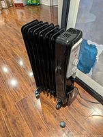 Front angled view showing overall heater and broken wheel cap on floor